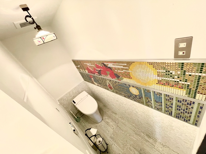 【洗面所】タイルアートで装飾された清潔感のあるトイレ。