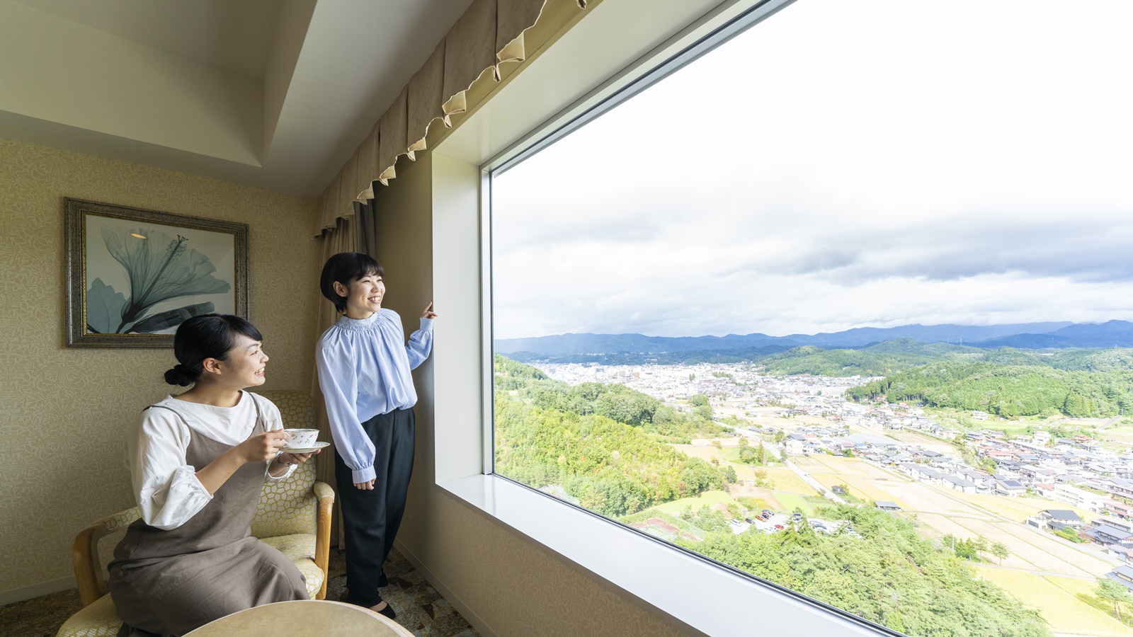 小高い丘の上にあり全室北アルプスビュー。大きな窓からは北アルプスの山をご覧いただけます。