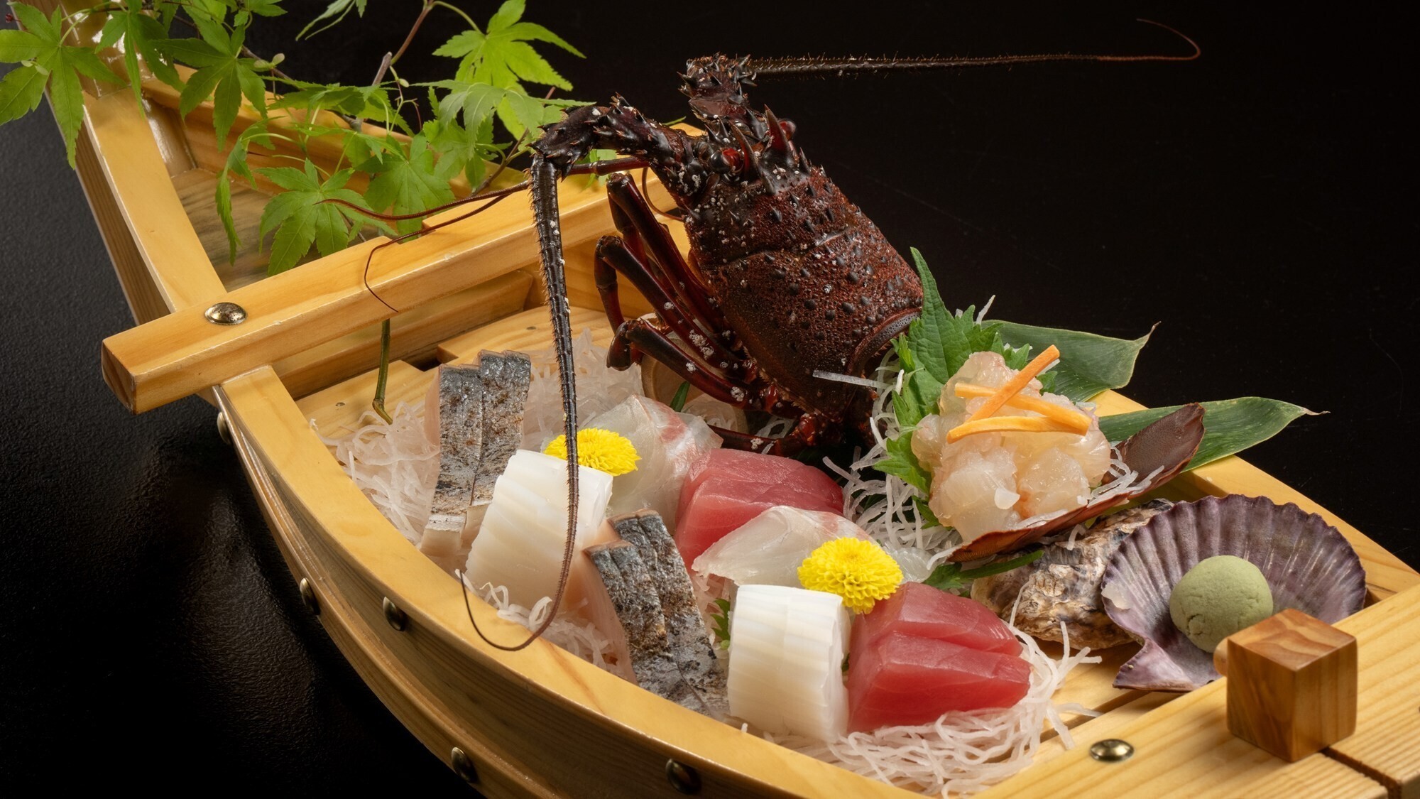 【夕食一例】伊勢海老のお造りを中心に、海辺の宿ならではの味覚をご堪能ください。