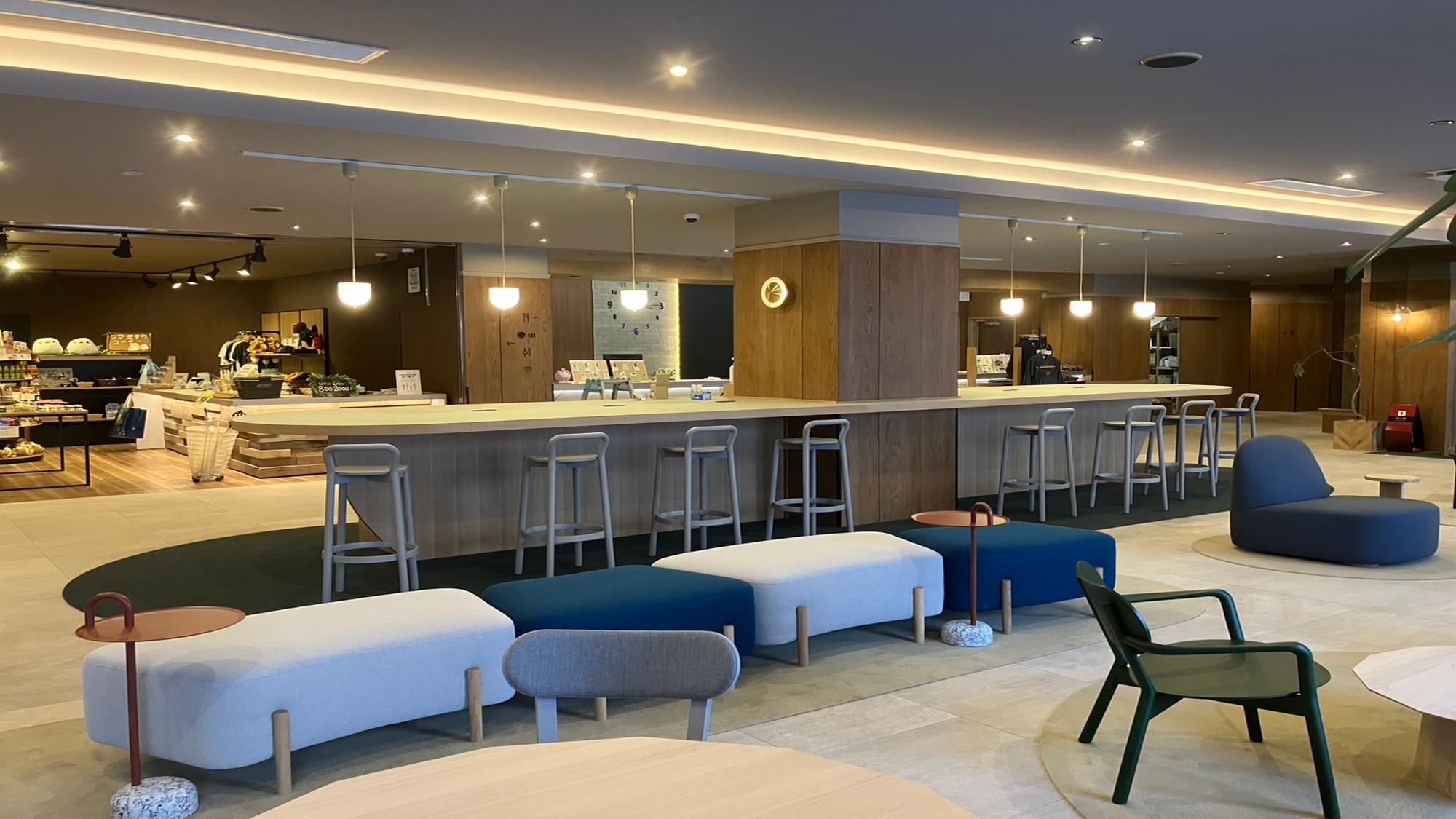 【ロビー】こだわりの旭川家具を使ったテーブルや椅子をご用意。向かい側には売店がございます。