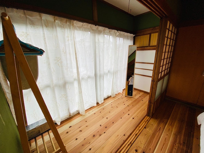 A full-length mirror, hangers and clothes rack are