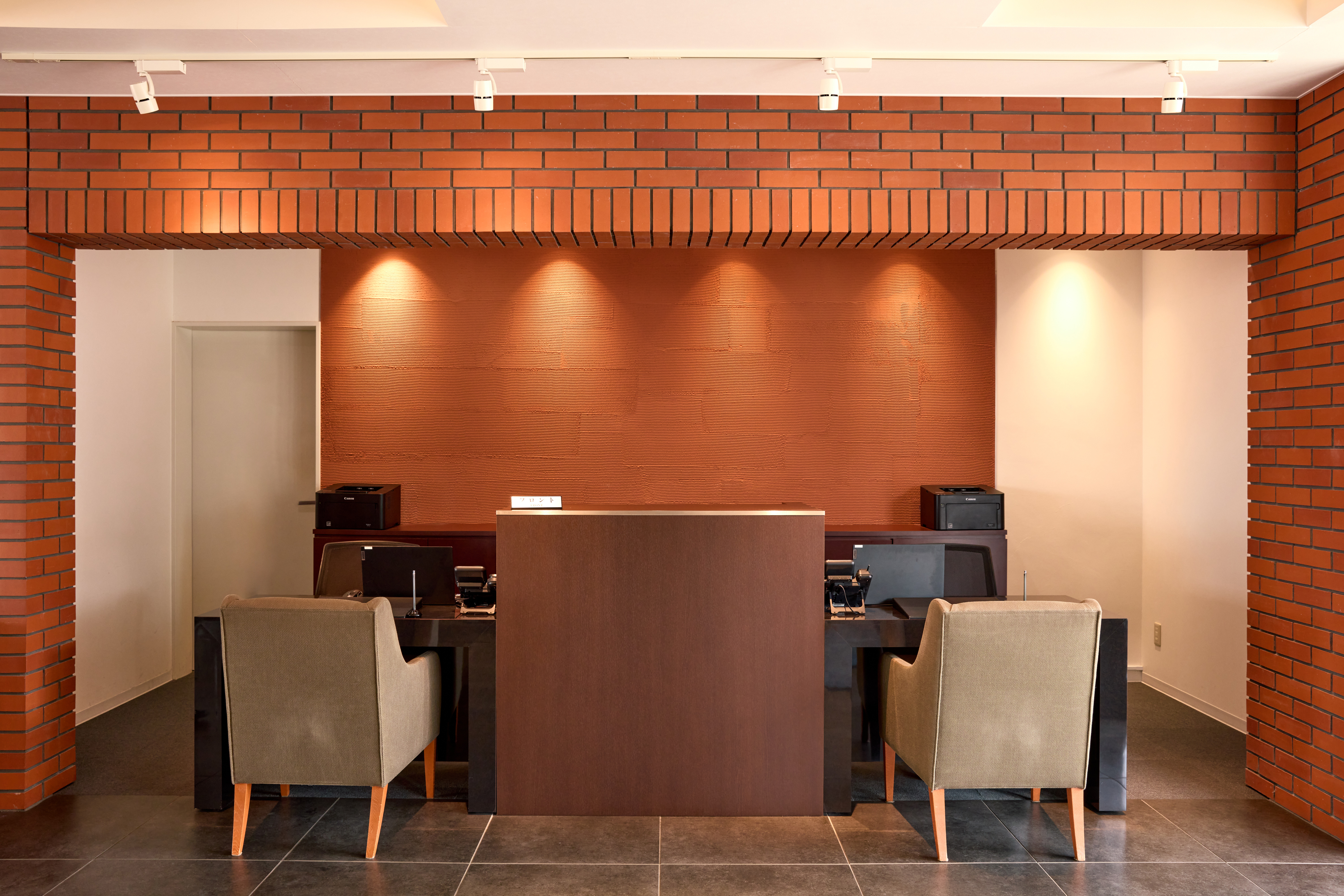 「レンガ」をイメージした落ち着いたフロントでスタッフがおもてなし