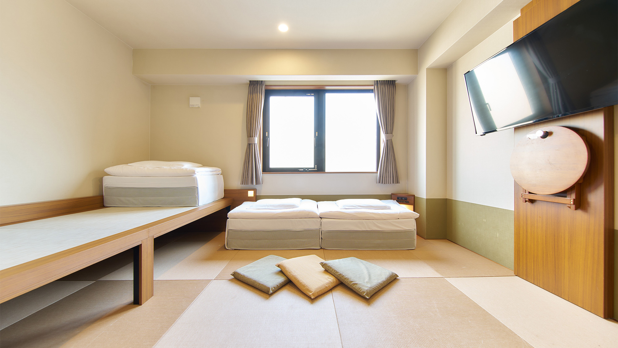 ・【トリプルルーム】自然光の差し込む明るいお部屋です。テレビの下に折り畳みテーブルもございます