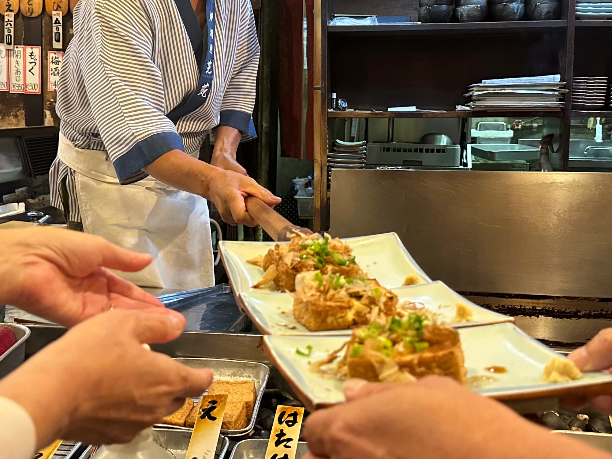 【当館から徒歩10分・炉ばた焼き「芝宛」】焼き上がったお料理をカウンター越しに渡し棒で届けてくれます