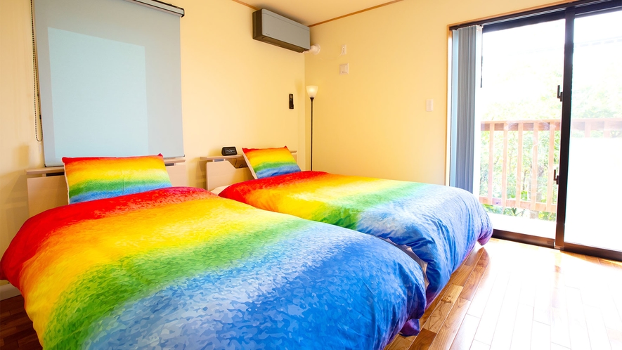 ・＜寝室一例＞寝具も鮮やかなレインボーで明るい雰囲気の寝室
