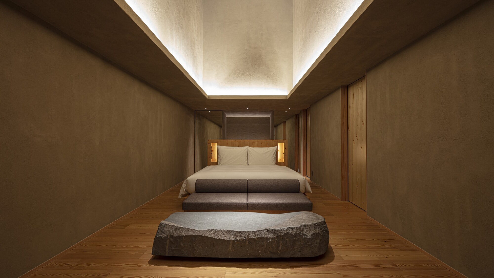 【SOKIスイート】66㎡／ベッド幅1,800mm　ソファや石材を用いたテーブルを備えております。