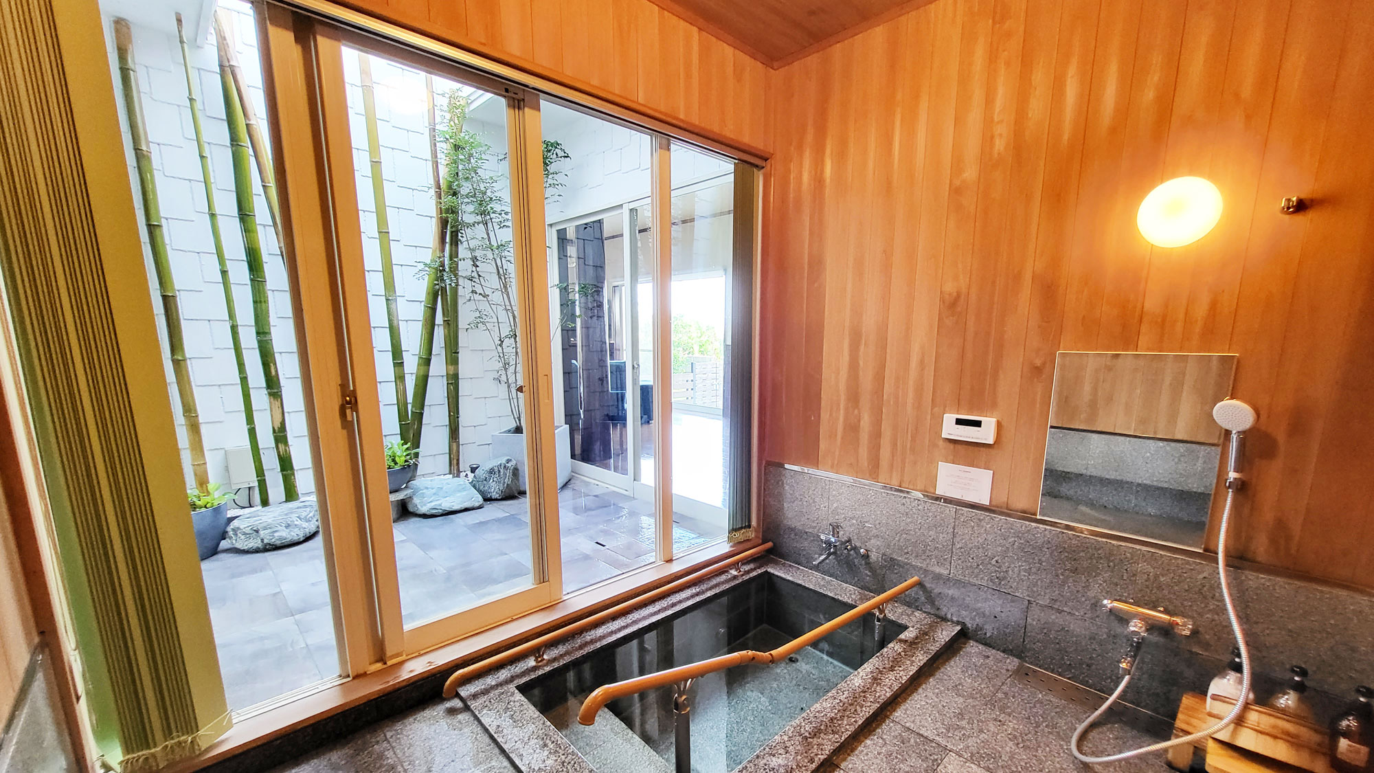 【1F/バスルーム】中庭と続いている石風呂は窓を開けると半露天風呂になります。