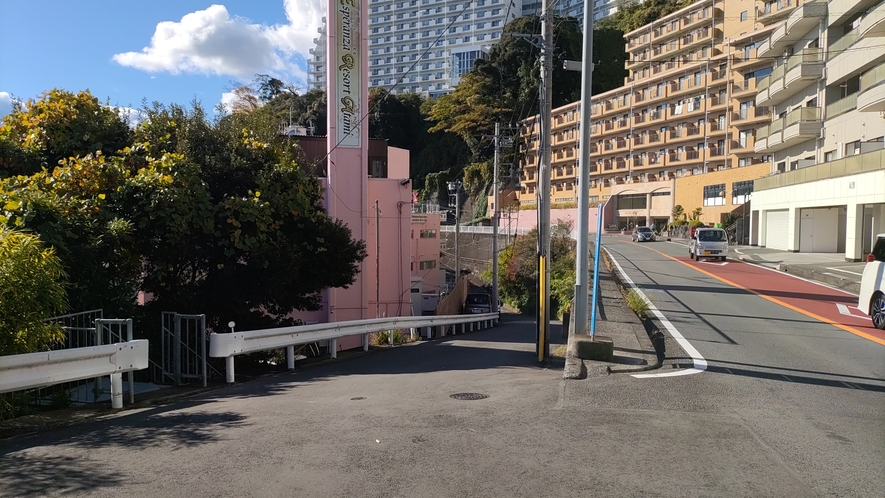【道案内】看板から３００ｍほど走るとピンク色の建物が見えますので左折し下り坂を降ります。