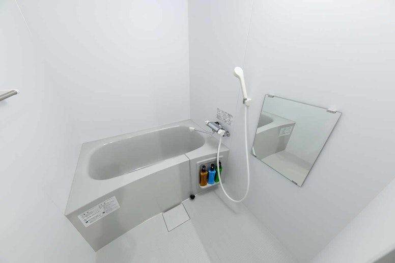 Comfortable bathroom! There is a bath tub and a...