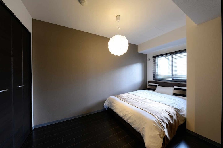 In a closet, a pair of single comforter and...