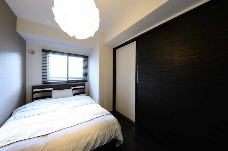 There is a sliding door between a bedroom and...