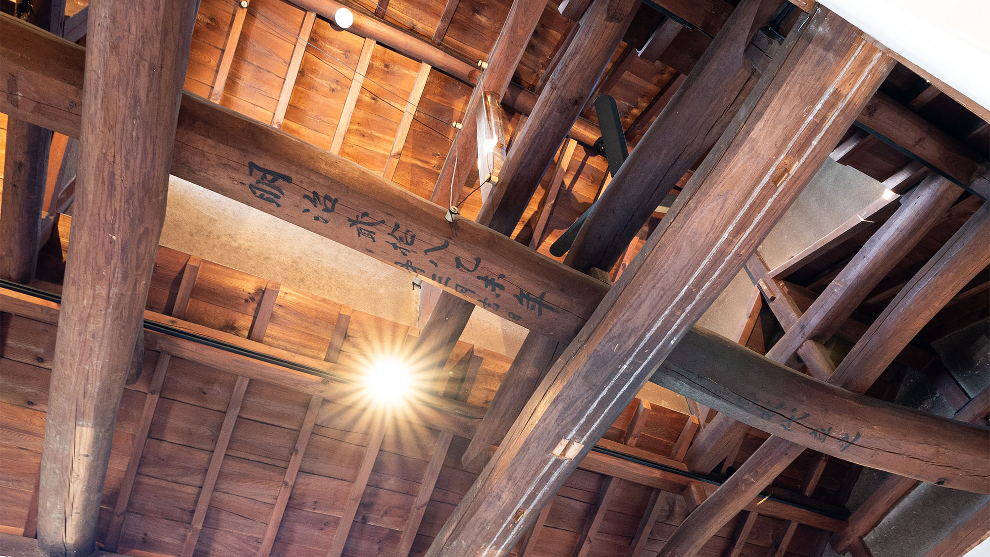 ・【OKAIKO寝室】天井の太い梁に刻まれた文字。蚕室時代の面影を感じさせます