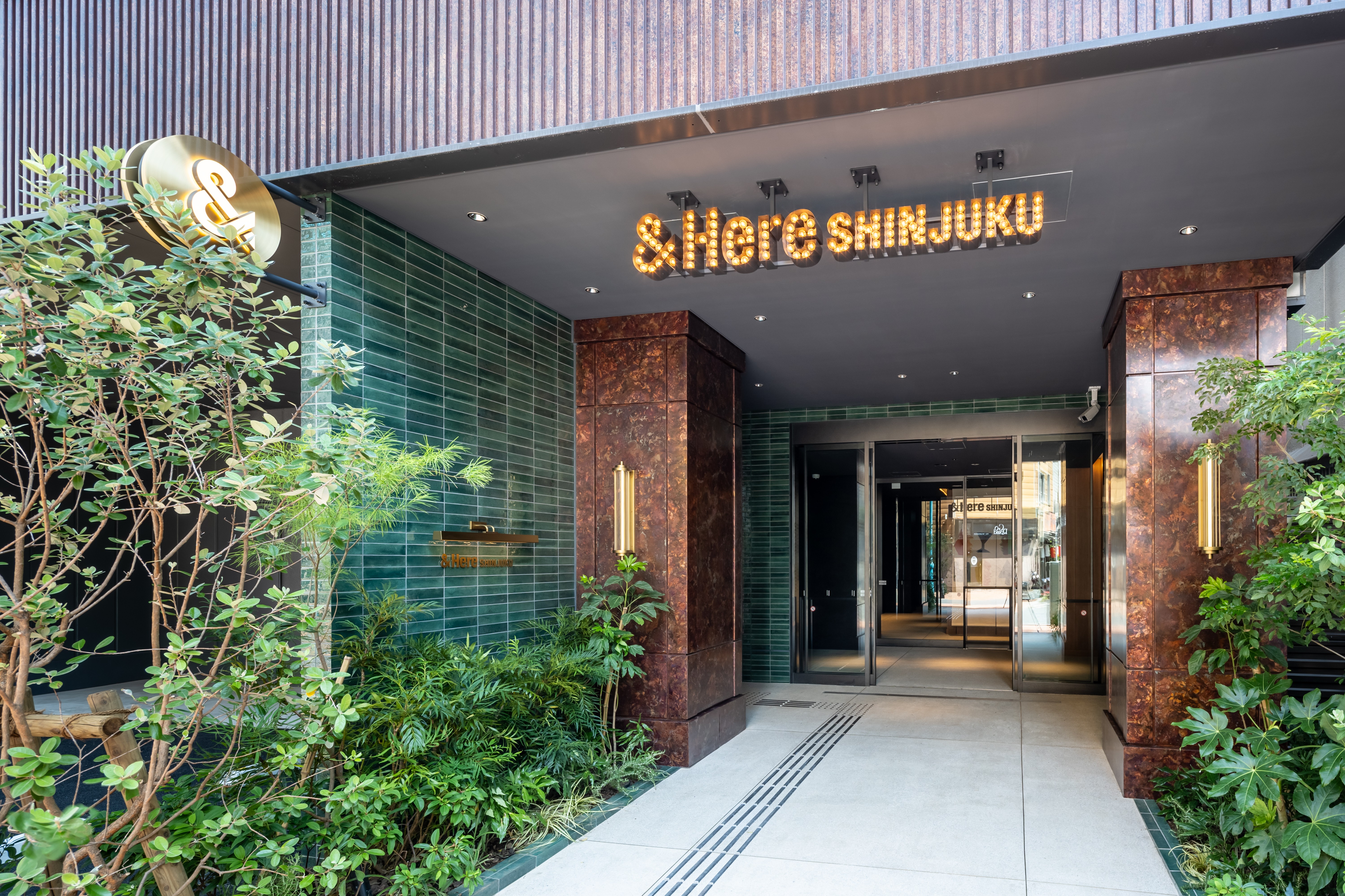 【1階エントランス】温かみのあるライトと心安らぐ植物が迎える、癒しの空間