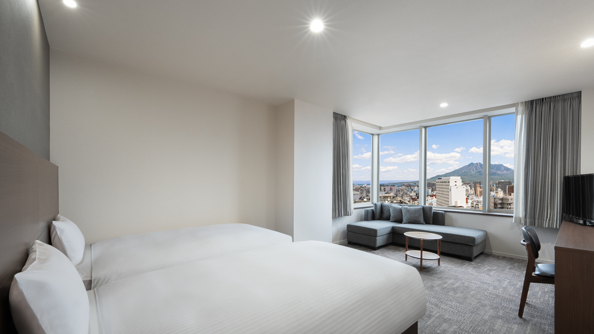 ◇上層階の角部屋に位置した、桜島を一望できるデラックスコーナーツイン。格別のホテルステイを