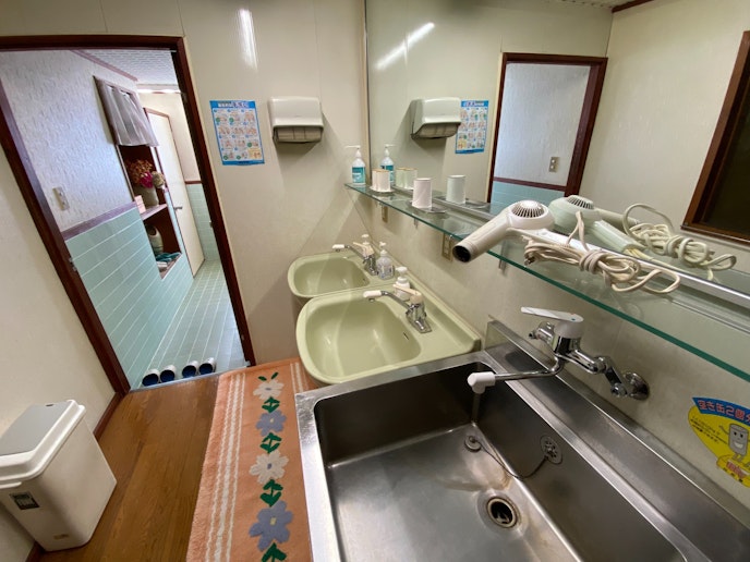 共同洗面スペース。清潔に保たれたシンクと鏡、ヘアドライヤーも完備しており、朝の準備に便利です。