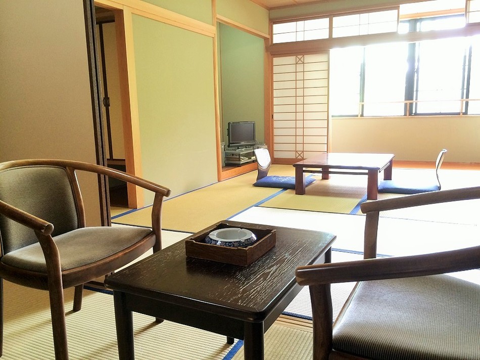 A large Japanese-style room with the next room in the foreground
