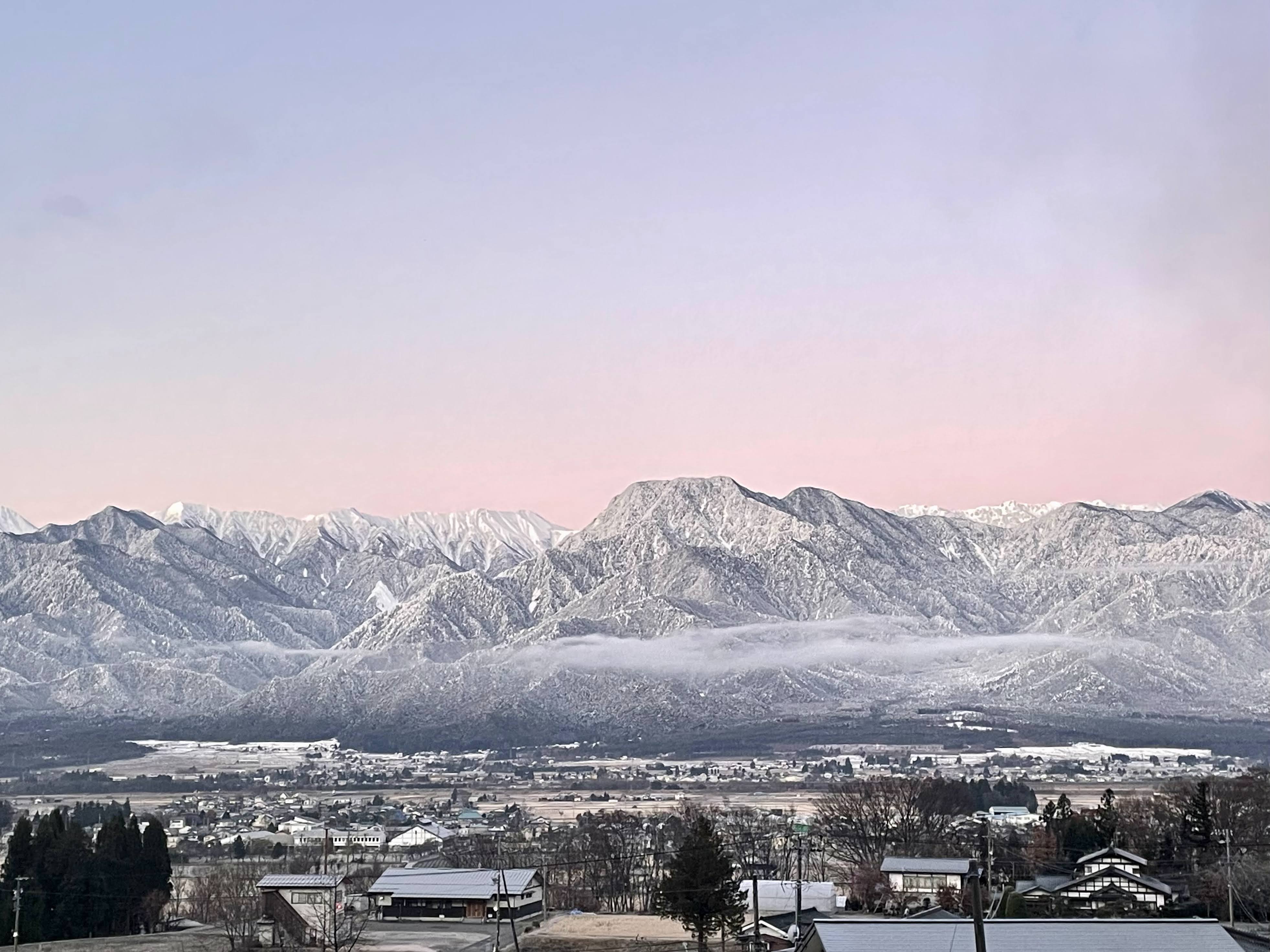 冬の朝は山が白く空は朝焼けのピンク色に染まり、幻想的な風景になります。