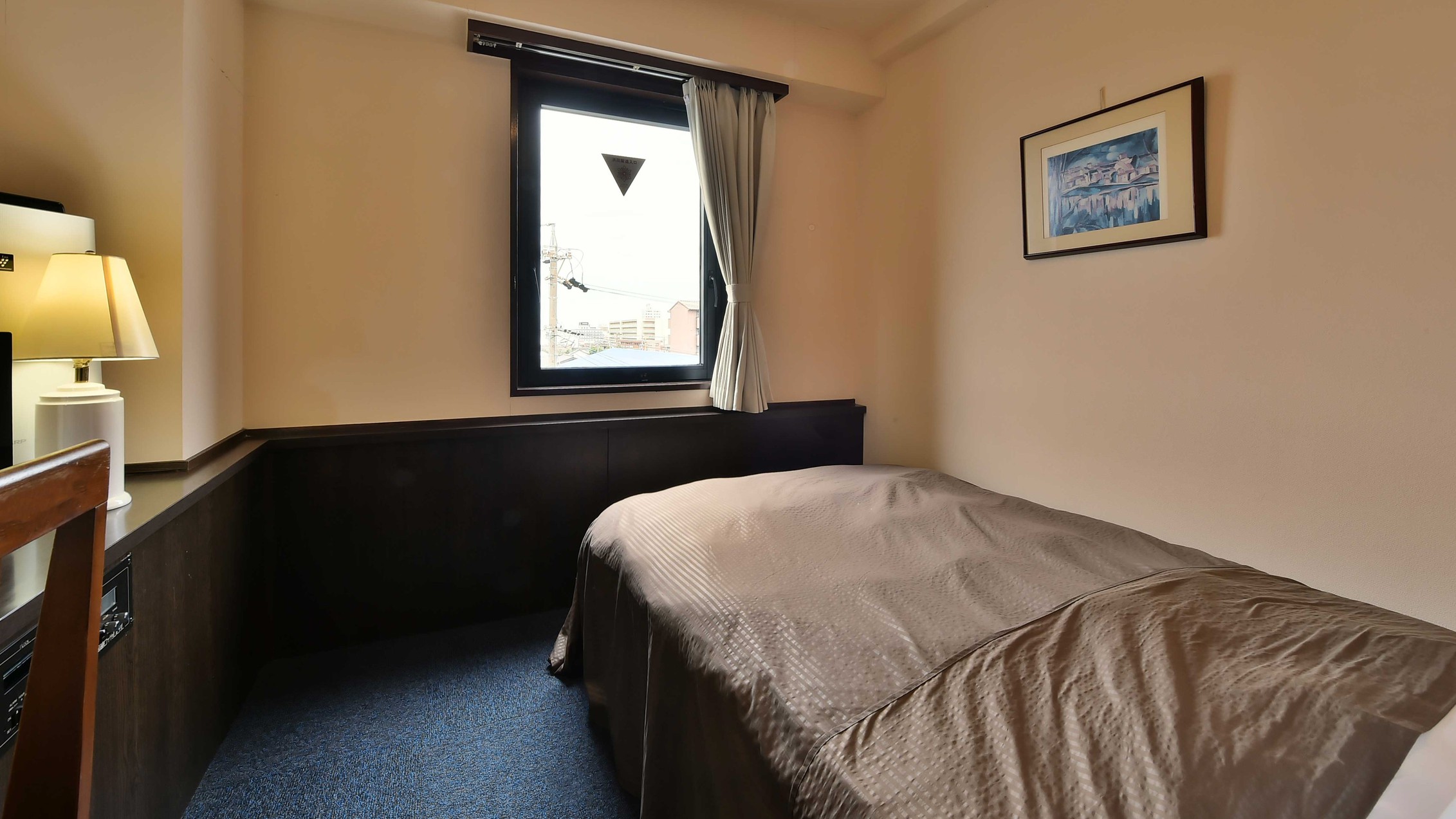 シングルルーム：広めのセミダブルサイズベッドでゆったりとおすごしいただけます。バス・トイレ付き