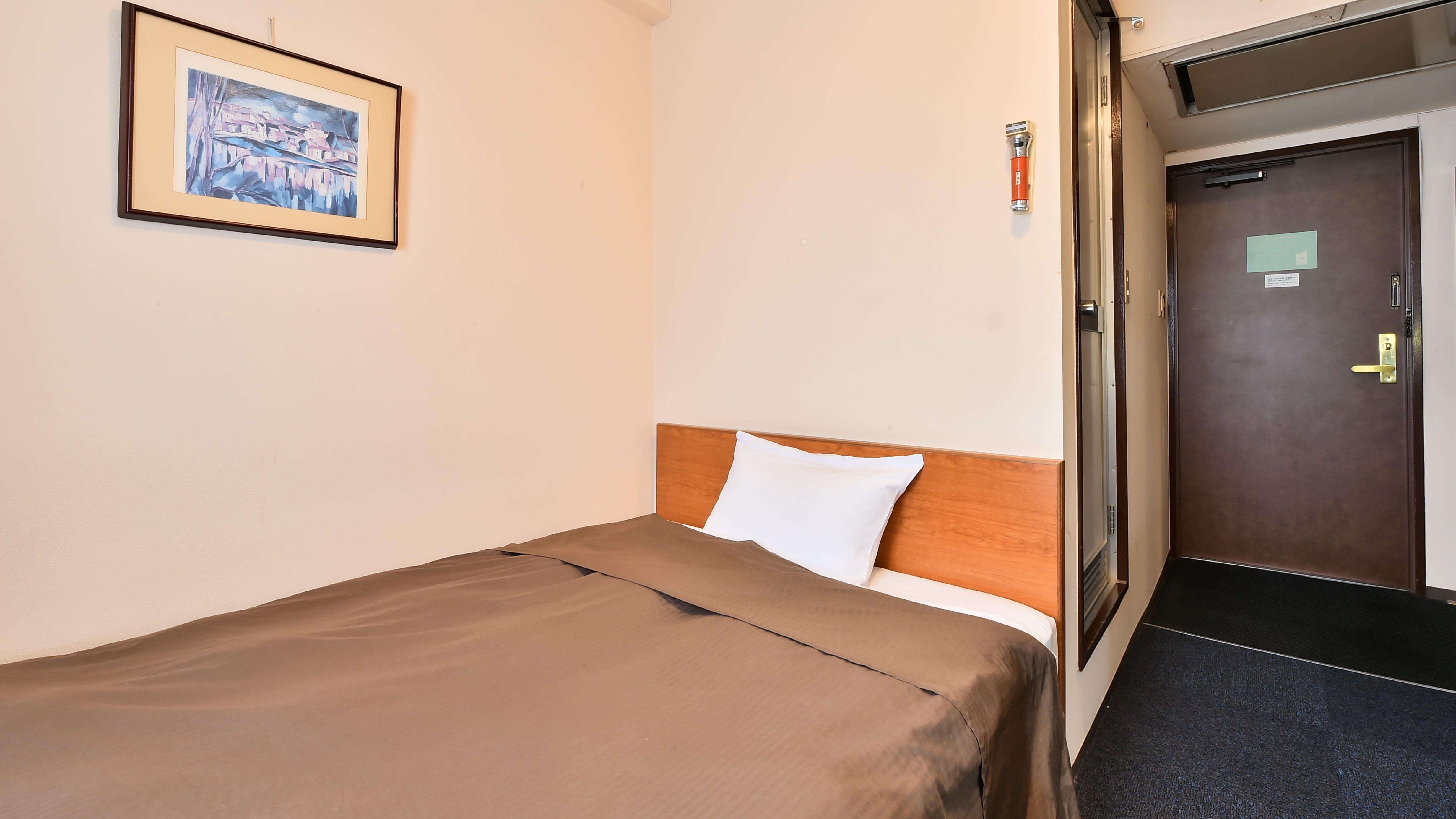 シングルルーム：広めのセミダブルサイズベッドでゆったりとおすごしいただけます。バス・トイレ付き