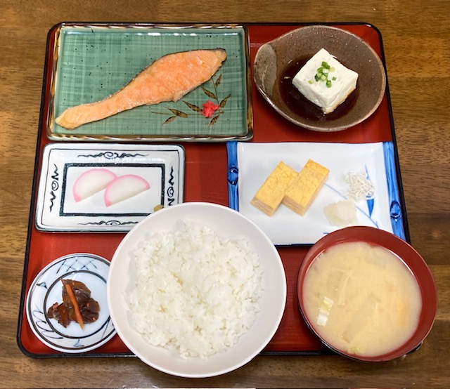 食事場所は食堂となります。時間は６時３０分～８時３０分です。お米は長野県産コシヒカリを使用しており、キレイな雪解け水と昼夜間の寒暖差が育んだ甘みが特徴です。お味噌汁は、米麹と大豆でつくる信州味噌（米味噌）を使用しており、淡色・辛口が特徴です。ご飯・お味噌汁ともに、おかわり自由でございます。料金は、990円（税込）です。※写真のメニューは例であり、内容は日ごとに異なります。