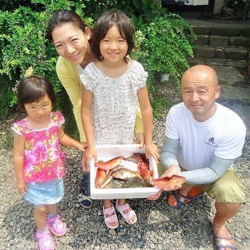 Parent and child fishing for small fish