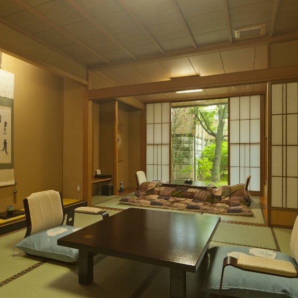 "Tsubakien" guest room with sunken kotatsu and open-air bath. Kotatsu in winter