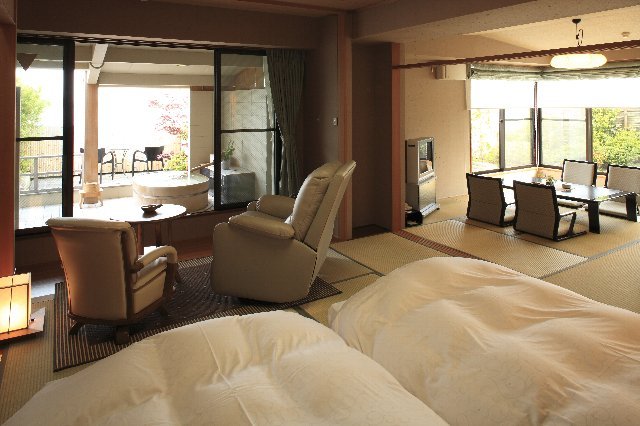 A spacious Japanese-style room with an open-air bath