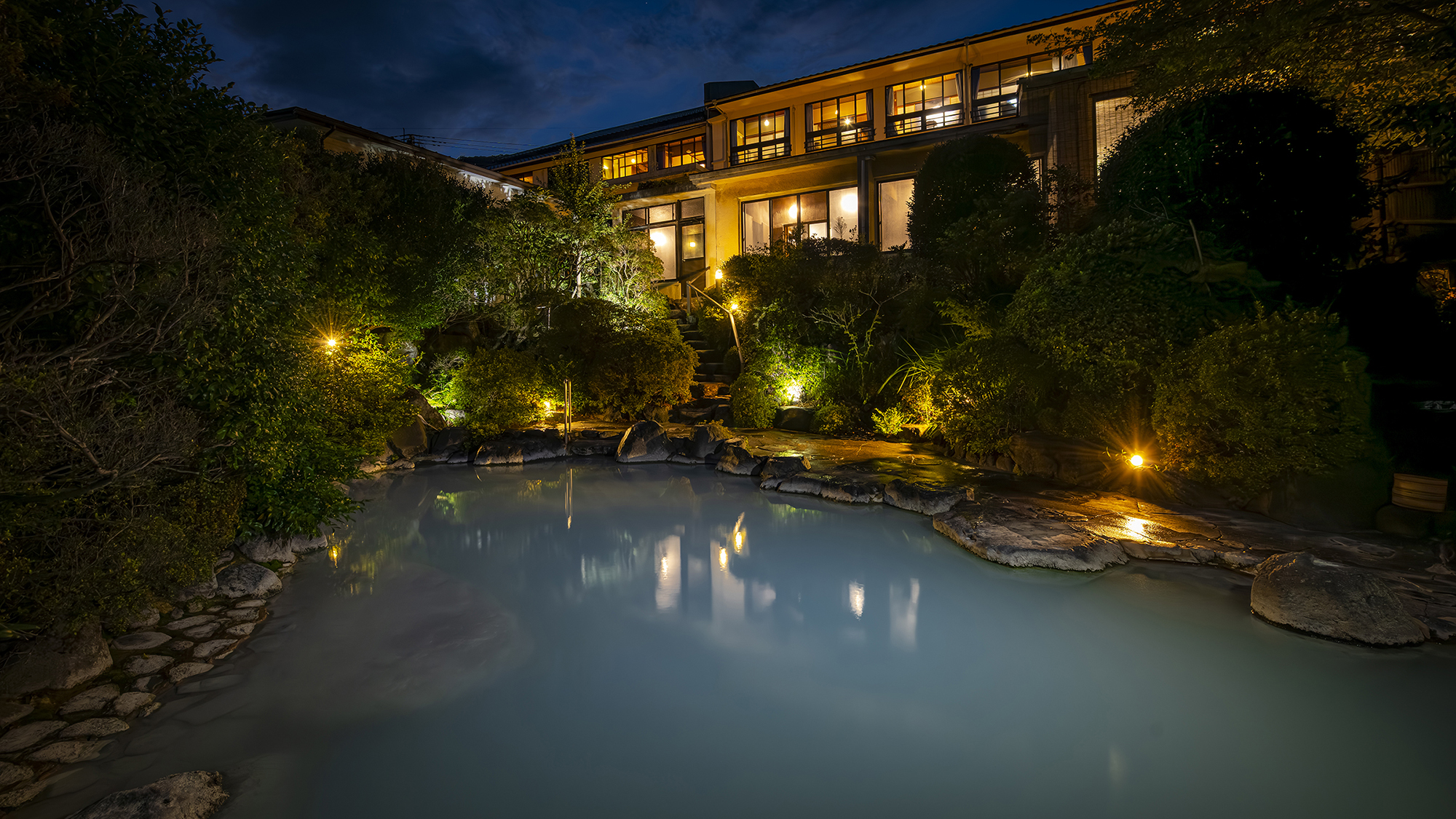 【露天風呂】夜は灯りが彩り神秘的な青磁色の湯に。心身共にリラックス。